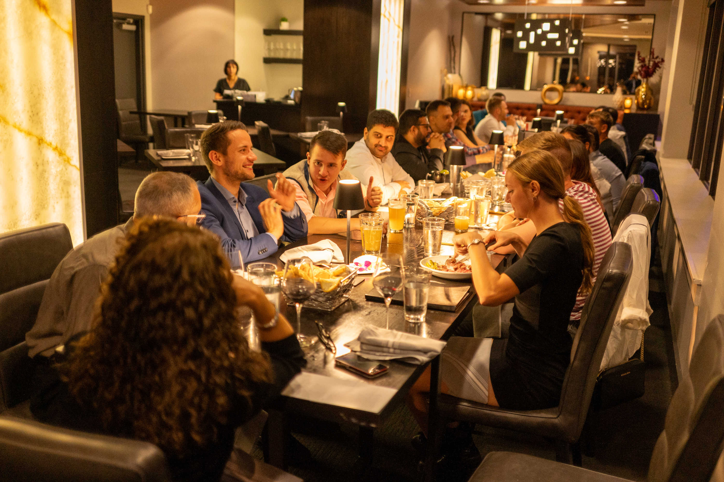 MBA students, Dr. Chambers and her family having dinner at Fahrenheit Rooftop Restaurant